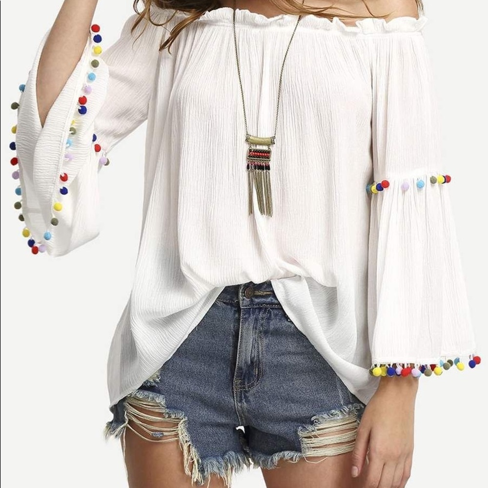 Over the shoulder top with rainbow Pom poms
